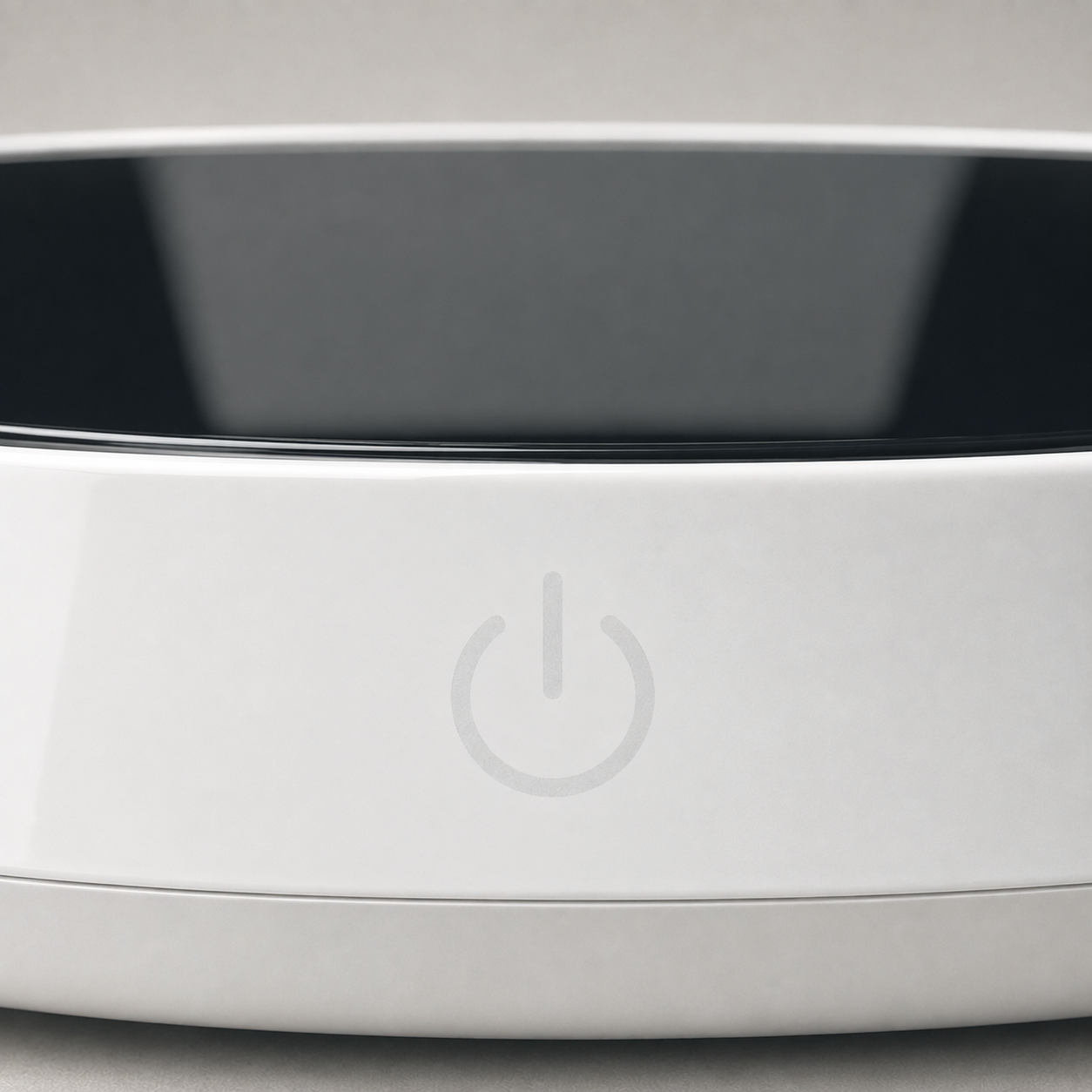 Close-up of the warmer's top edge showing the black glass plate and the power symbol