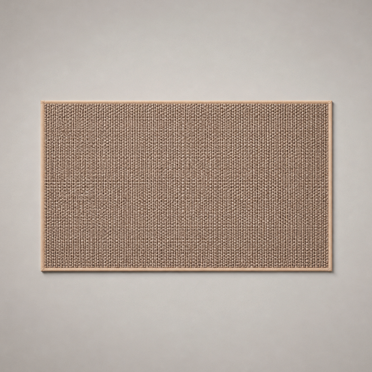 Beige woven kitchen rug photographed flat from above on a grey studio background