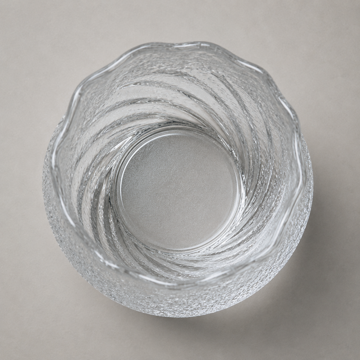 Looking down into the tumbler at its rippled inner wall and plain flat glass base
