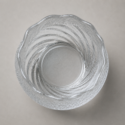 Looking down into the tumbler at its rippled inner wall and plain flat glass base