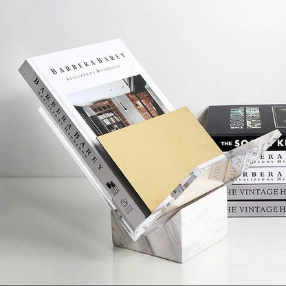 White marble holder with a hardback book in the clear acrylic V beside its gold-toned divider