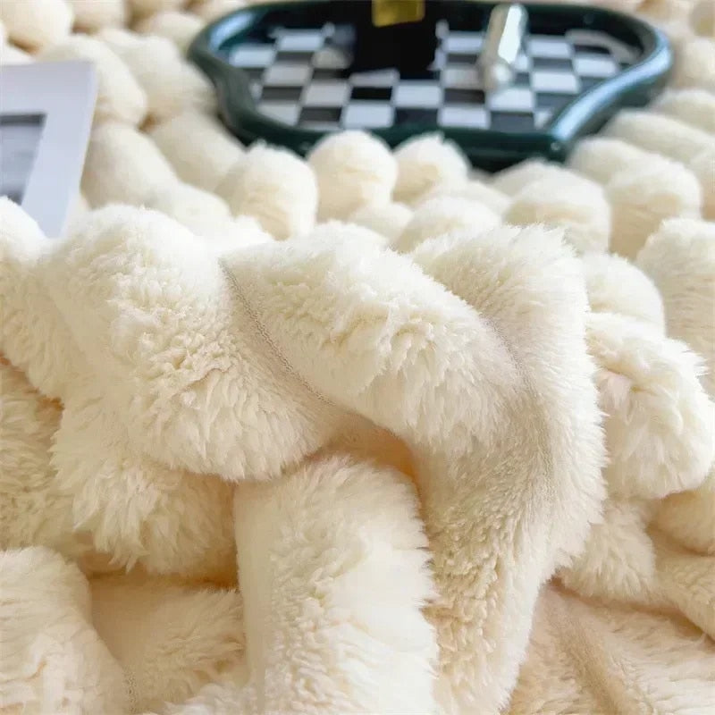 Macro of the cream faux rabbit fur throw, its fluffy pleats gathered into soft folds