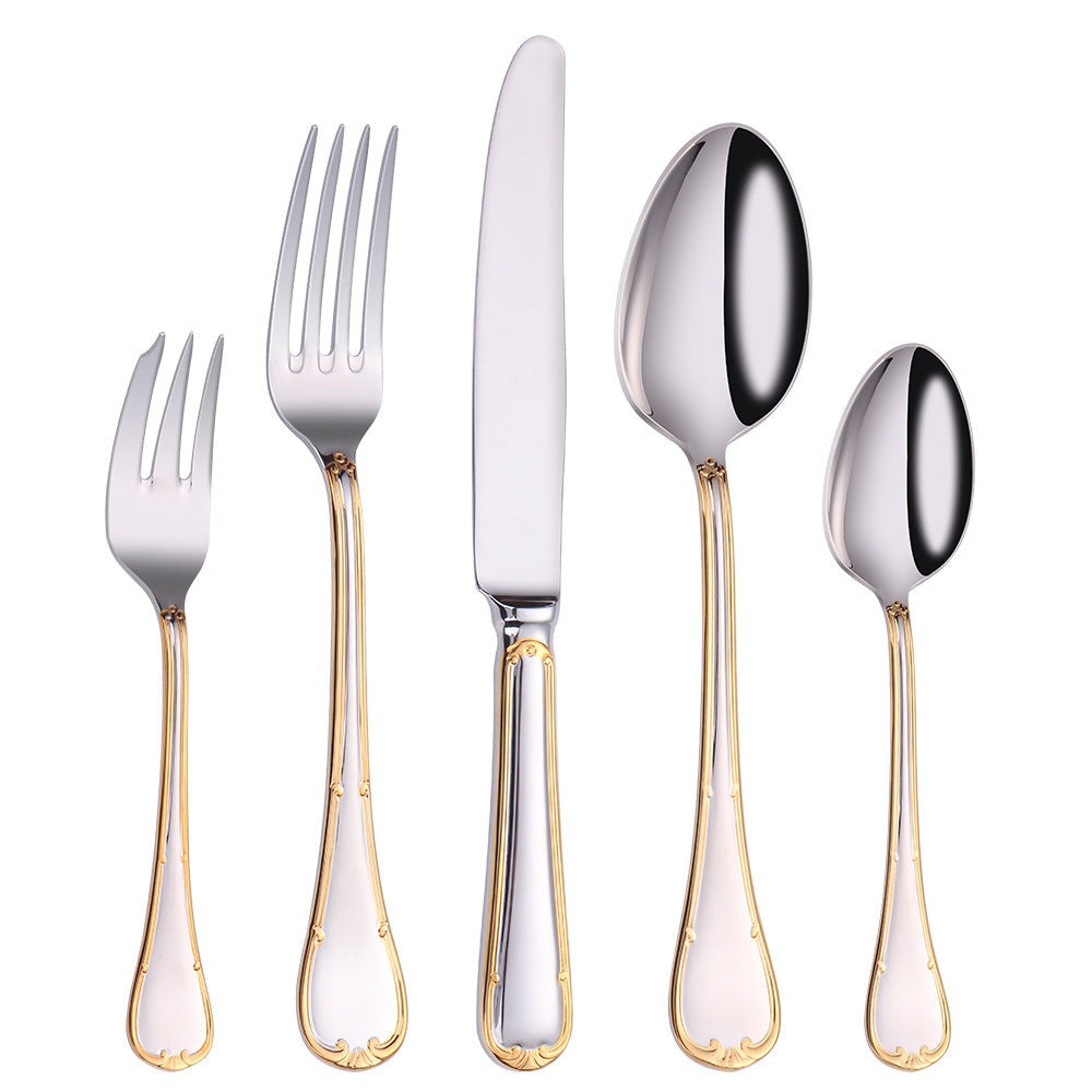 Cake fork, dinner fork, dinner knife, dinner spoon and teaspoon standing in a row on white