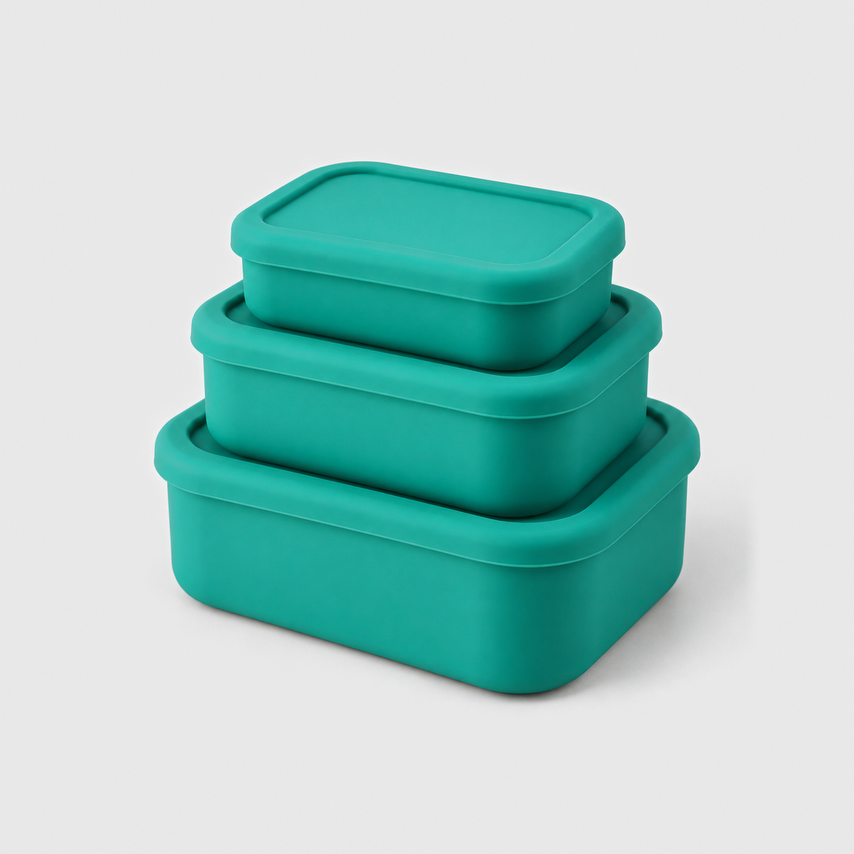 Three green silicone food storage containers in small, medium and large, stacked with their lids on