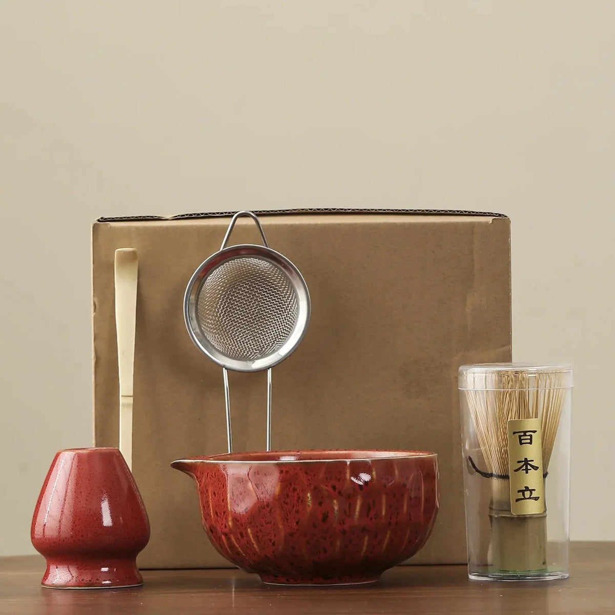 Red matcha set: whisk stand, bamboo scoop, steel sifter, spouted ceramic bowl and bamboo whisk in its clear tube