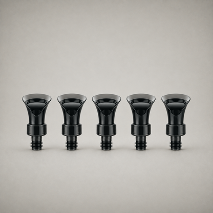 All five wine bottle stoppers in the set, in a row on a studio background