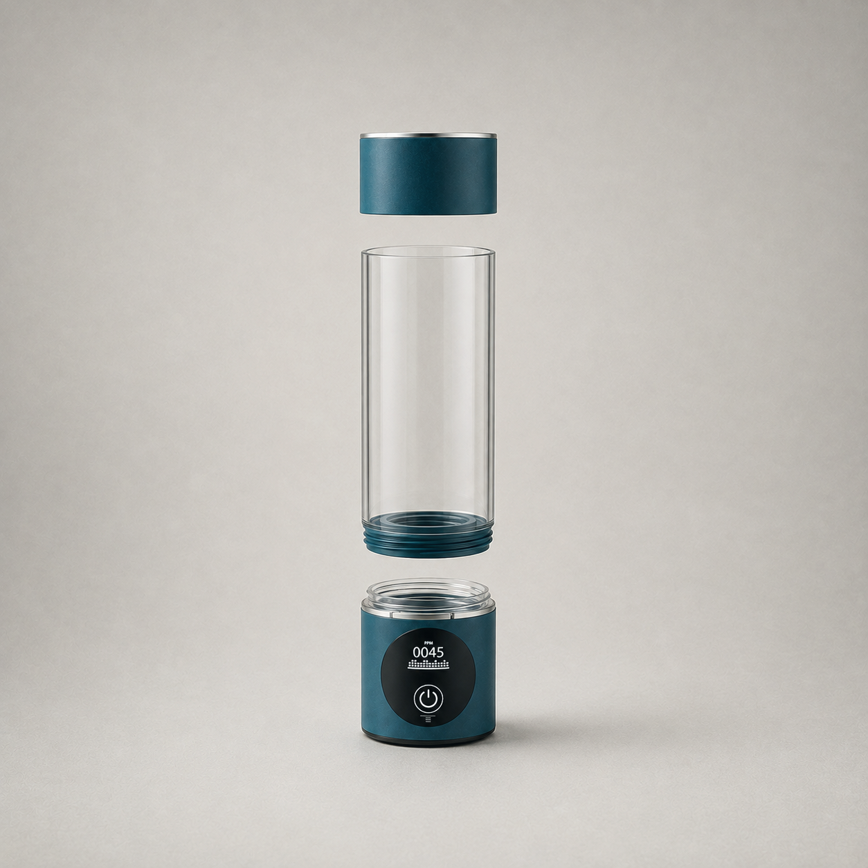 The bottle taken apart on plain grey: cap above, clear chamber with its threaded collar in the middle, base unit below