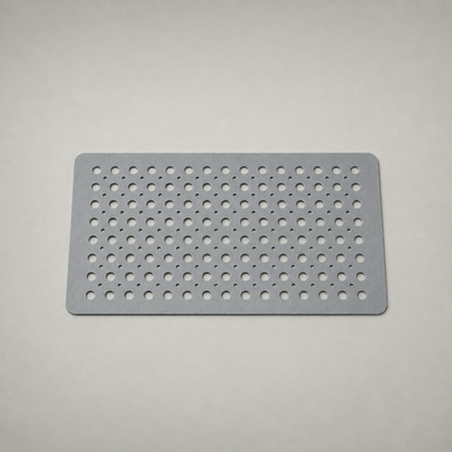 Gray non slip shower mat photographed whole on a plain grey studio background