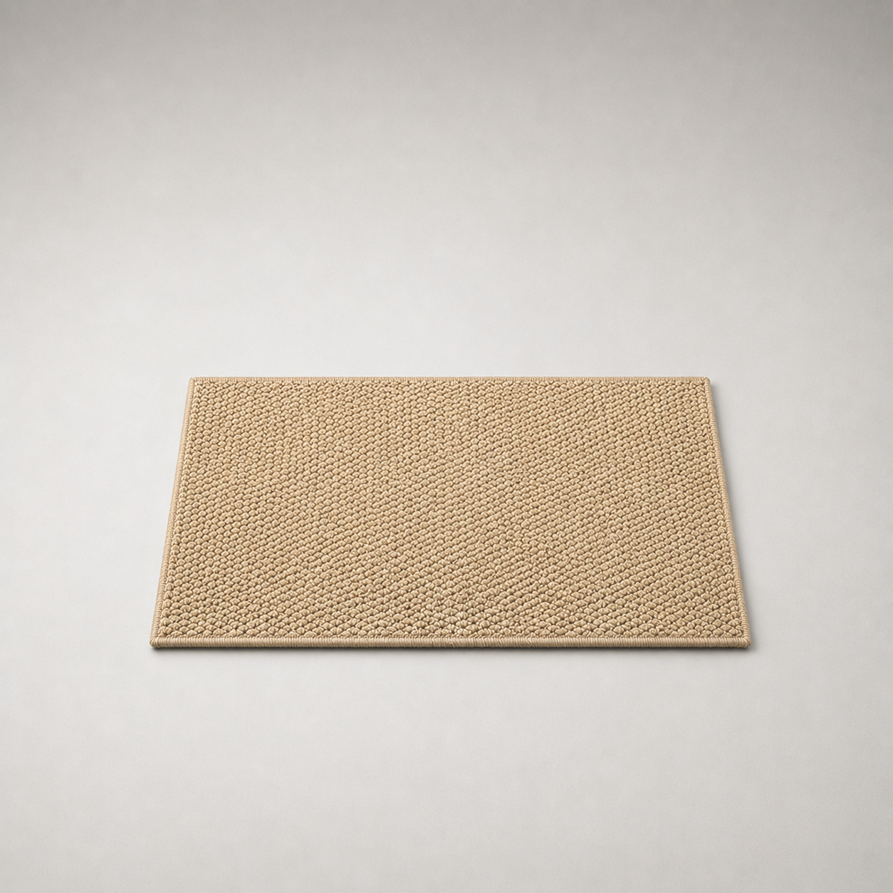 Beige loop pile doormat lying flat on a plain grey studio background, seen from above and slightly to the front, showing the rectangular shape, the overlocked edge and the depth of the pile at the near edge