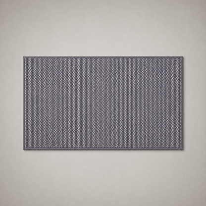 Gray woven kitchen rug photographed flat from above on a grey studio background
