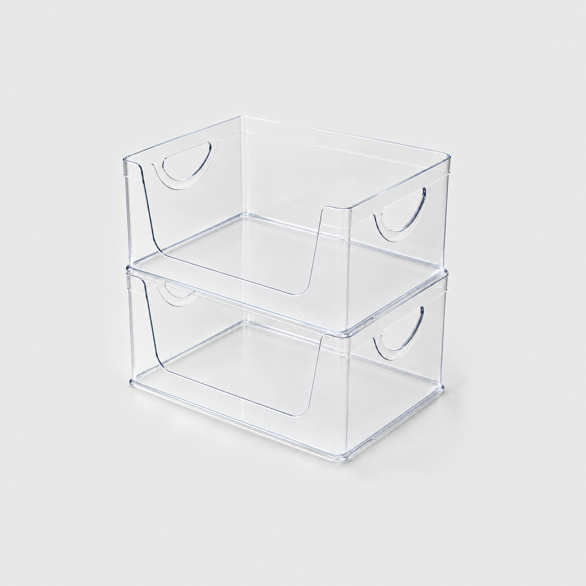 Two empty clear open-front pantry bins stacked on a light grey background
