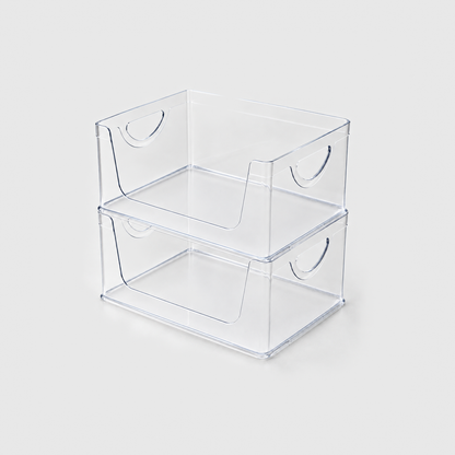 Two empty clear open-front pantry bins stacked on a light grey background