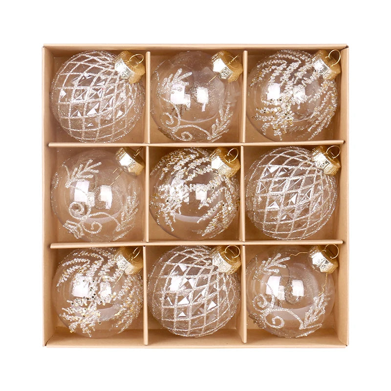 Champagne set of 9 clear glitter baubles with lattice, frond and scroll designs in an open kraft box, seen from above