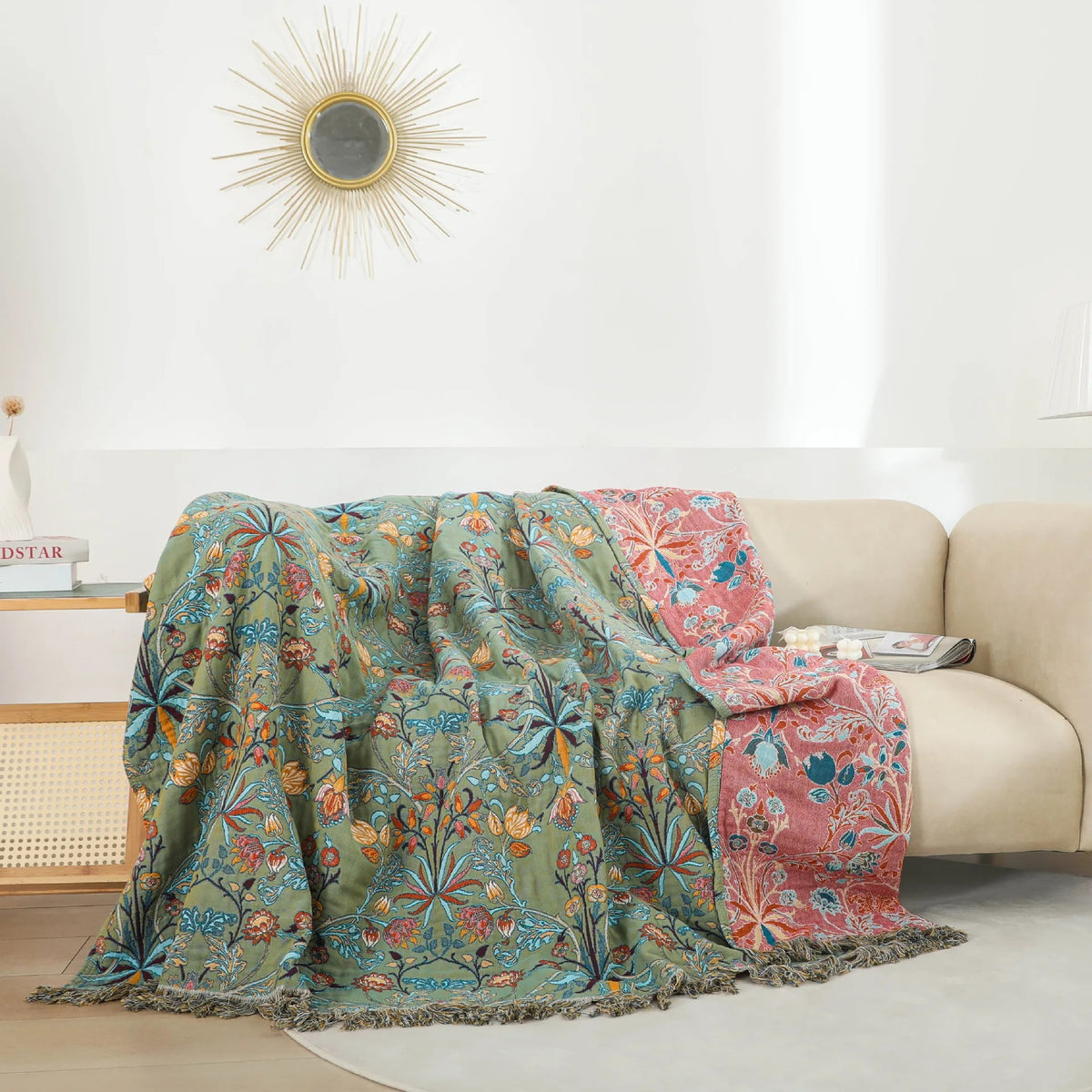 Bedspread thrown over a cream sofa in a white living room