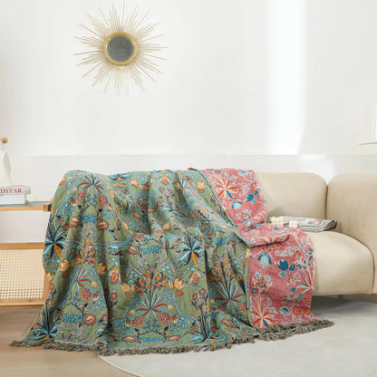 Bedspread thrown over a cream sofa in a white living room