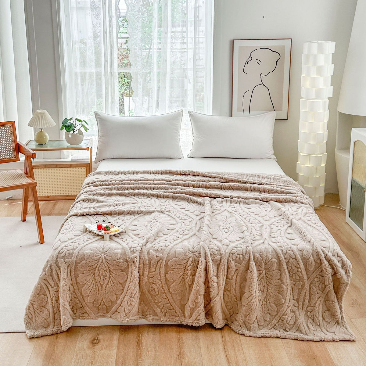 Beige embossed fleece blanket over a bed with a tray on top