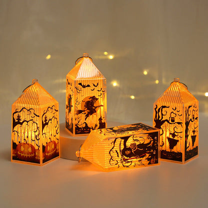 Four lit mini Halloween lanterns around a plinth, one lying on its side to show the ribbed roof and ring