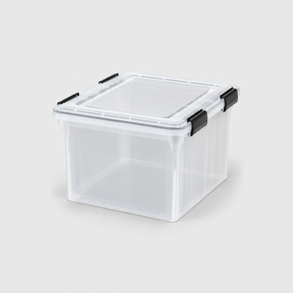 Empty clear file storage box with its lid latched shut on a light grey background