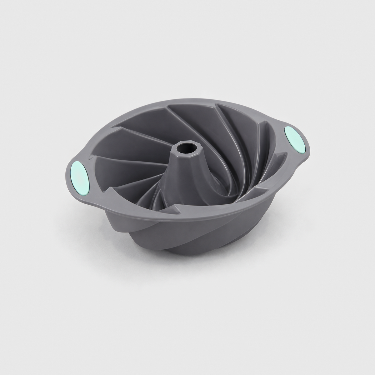 Gray silicone spiral bundt pan with twisted flutes, an open center tube and mint-green pads, on a light gray background