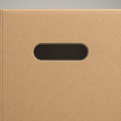 Close-up of the die-cut hand hole in the end of a cardboard moving box, corrugated flutes visible in the cut edge