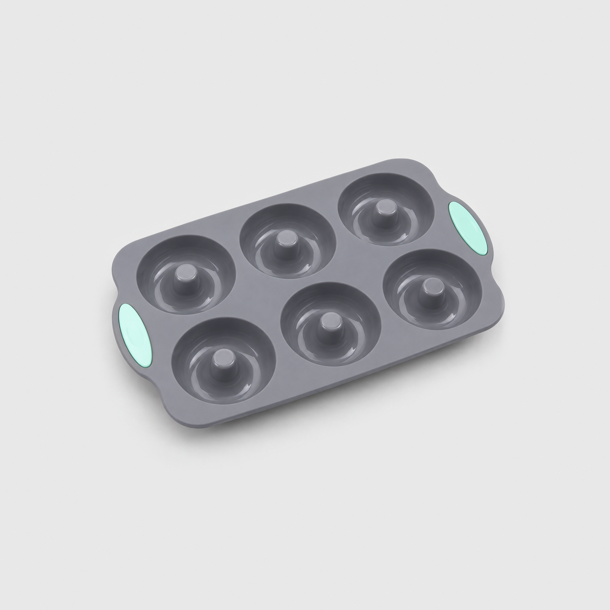 Gray silicone 6-cavity donut pan with mint-green pads at both ends, on a light gray background