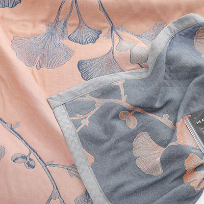 Close-up of the peach face with slate leaves beside the slate gray reverse with peach leaves