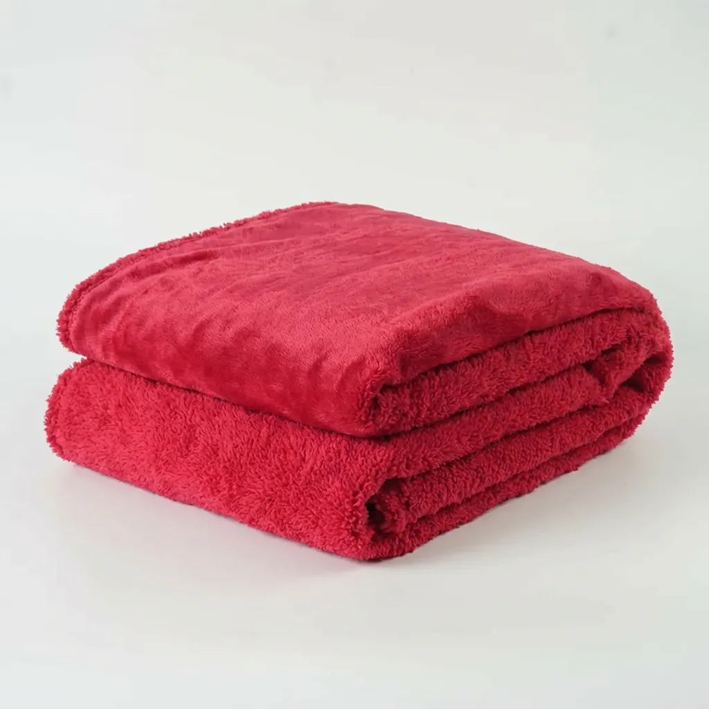 Red waterproof blanket with a long shaggy pile, folded in a stack
