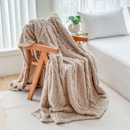 Beige fleece blanket draped over a wooden armchair