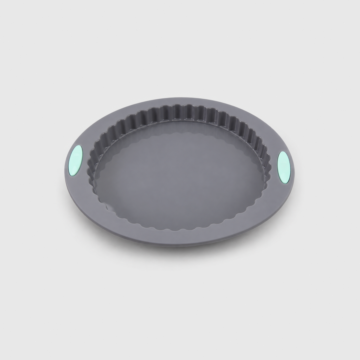 Gray silicone fluted tart pan with a wide flat brim and two mint-green pads, on a light gray background