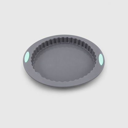 Gray silicone fluted tart pan with a wide flat brim and two mint-green pads, on a light gray background