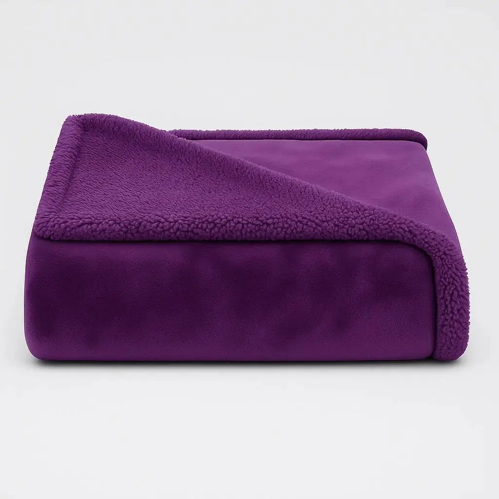 Deep purple waterproof blanket folded to show its plush face and sherpa reverse