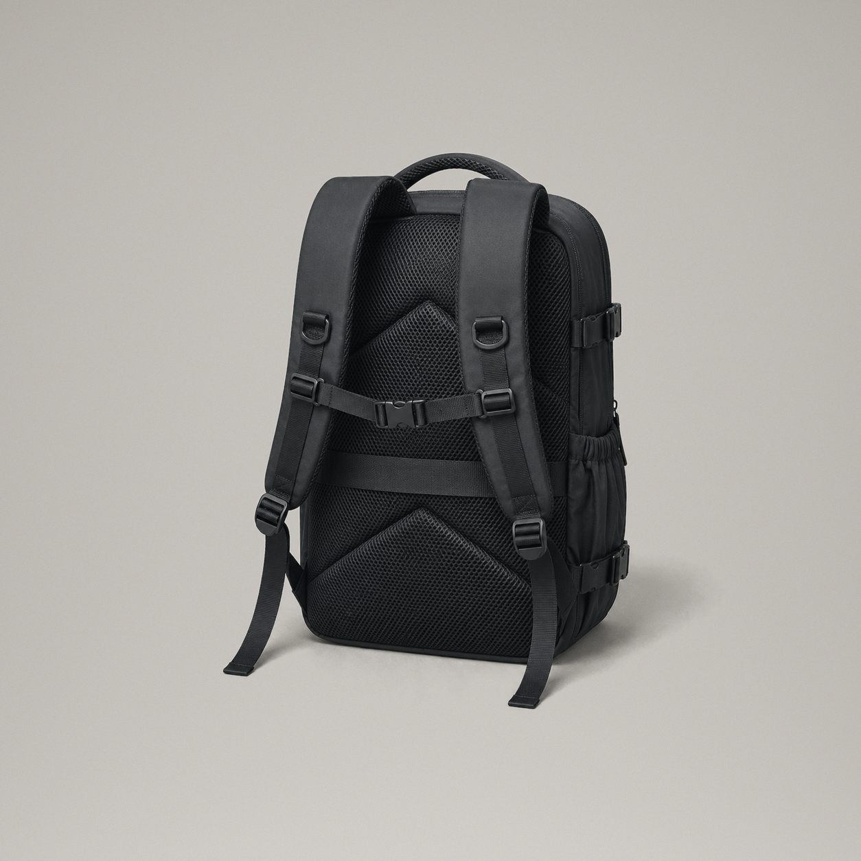 Back panel of the black laptop backpack showing the padded mesh chevrons, shoulder straps and chest strap