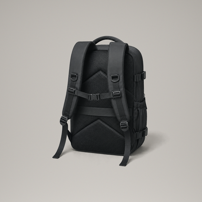 Back panel of the black laptop backpack showing the padded mesh chevrons, shoulder straps and chest strap