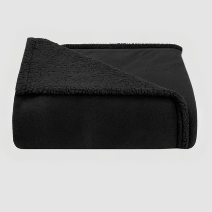 Black waterproof blanket folded to show its plush face and sherpa reverse