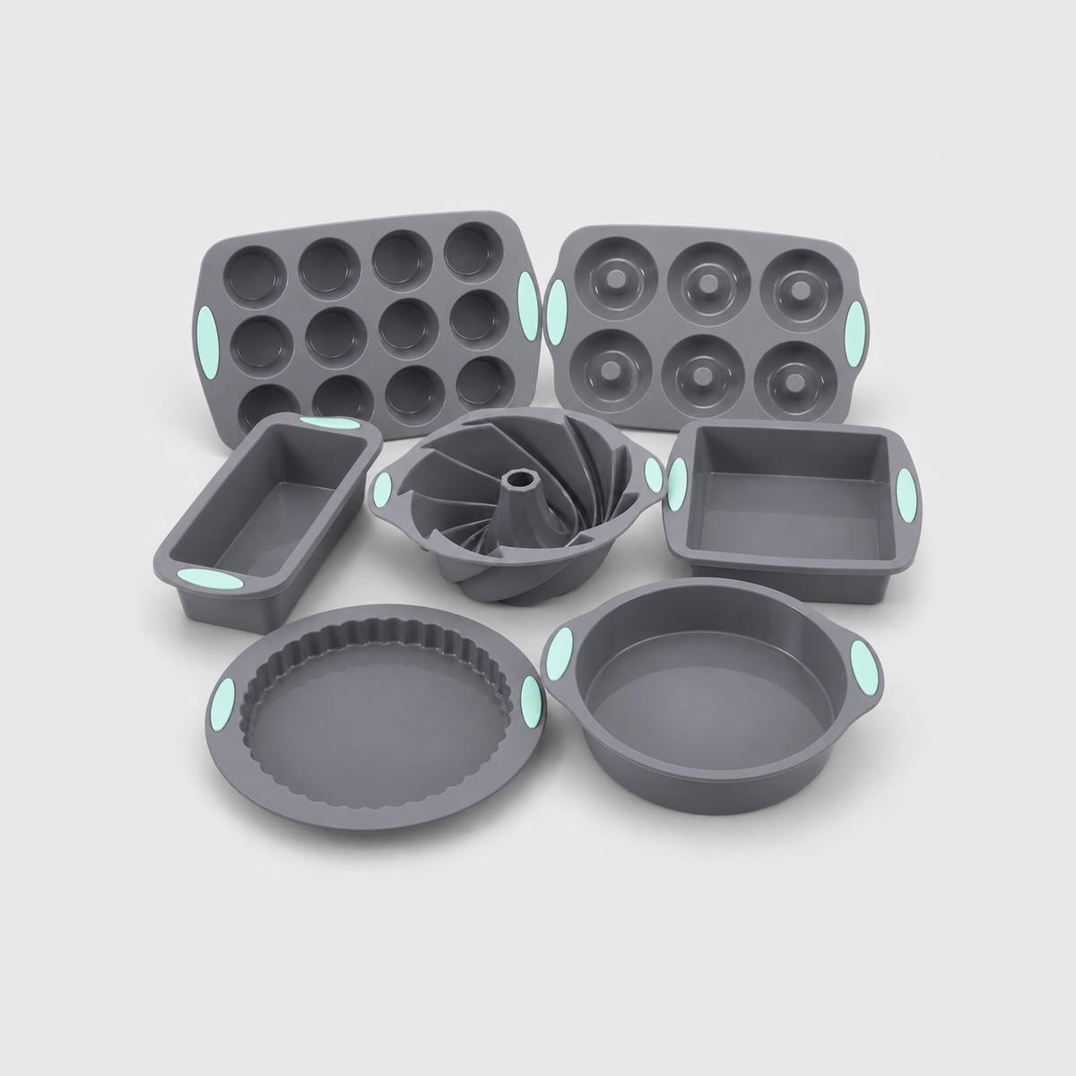 All seven gray silicone baking pans together: loaf, muffin, round, square, bundt, donut and tart