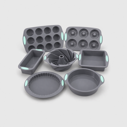 All seven gray silicone baking pans together: loaf, muffin, round, square, bundt, donut and tart