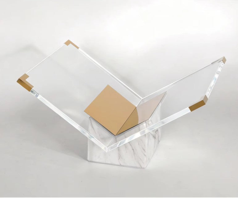 White and gold marble stand seen from above, with a gold-toned cap on each outer corner of the acrylic