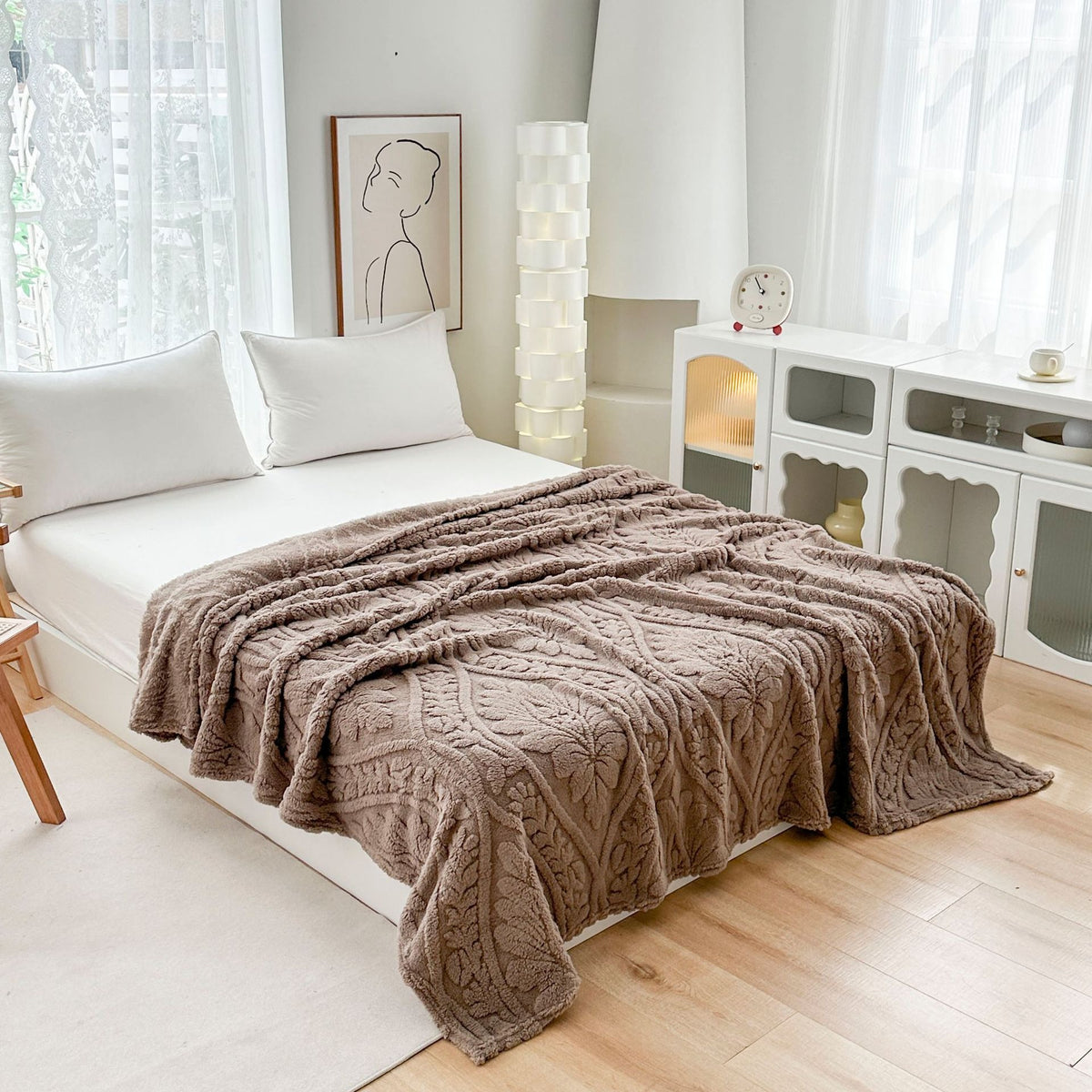 Brown embossed fleece blanket spread across a bed