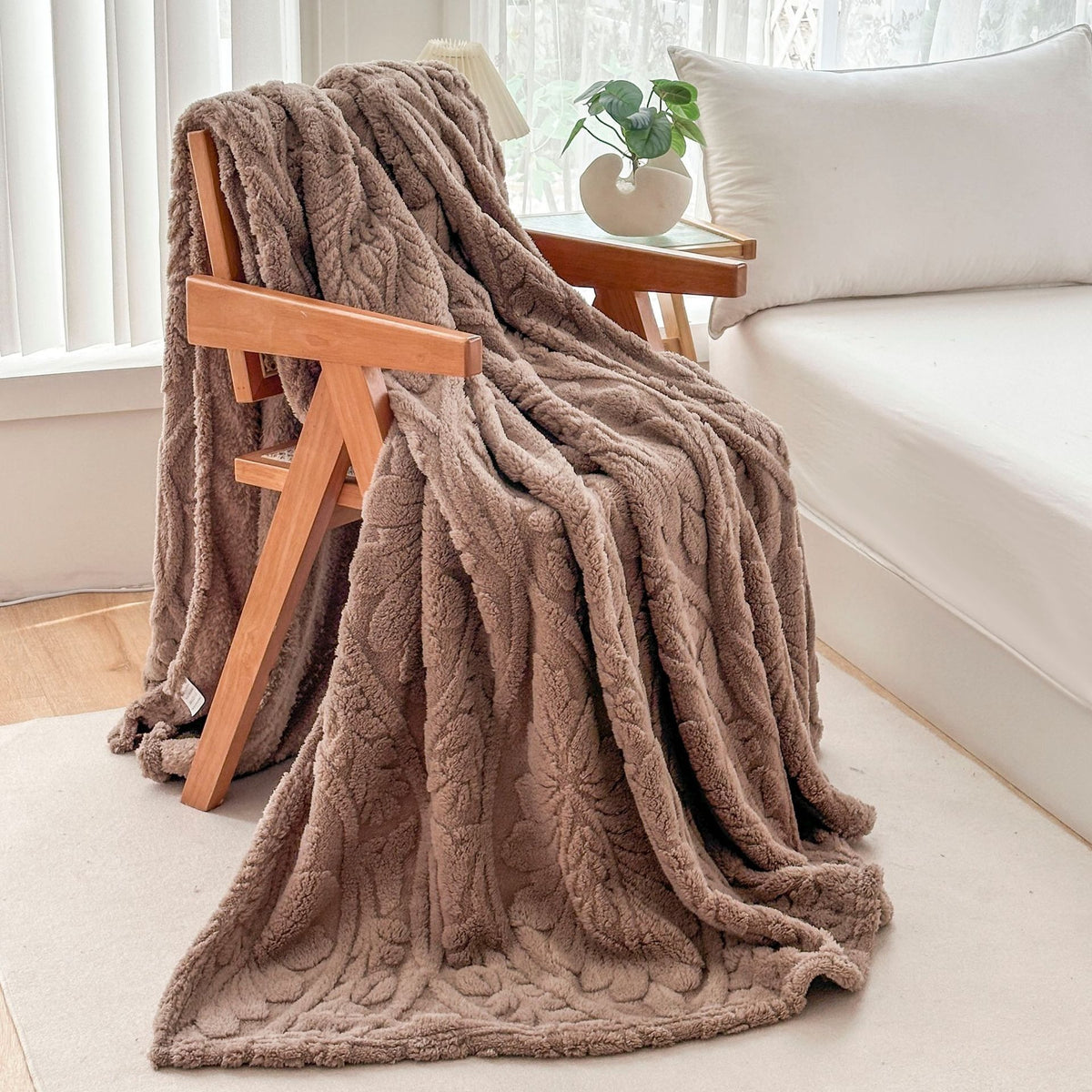 Brown fleece blanket draped over a wooden armchair
