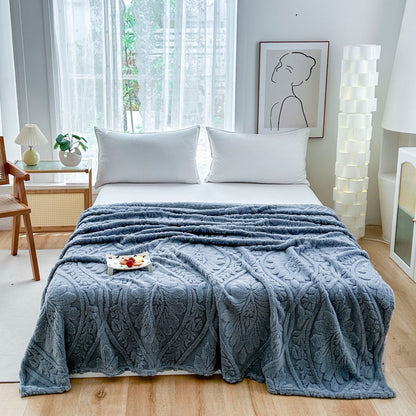 Blue embossed fleece blanket over a bed with a tray on top