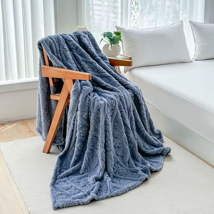 Blue fleece blanket draped over a wooden armchair