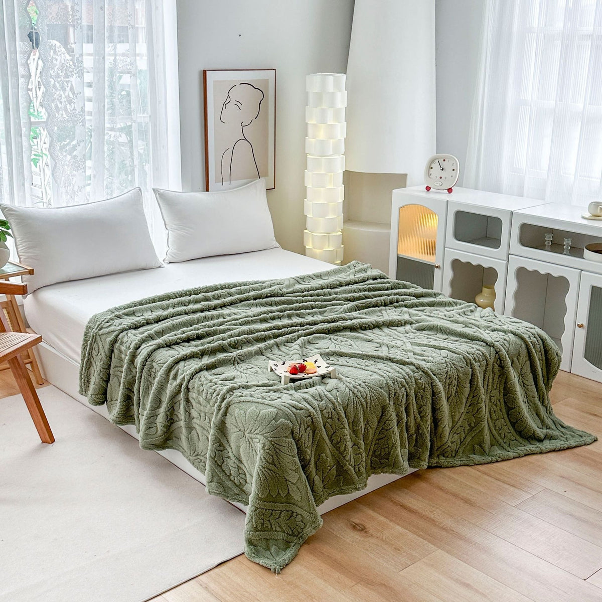Green embossed fleece blanket over a bed with a tray on top