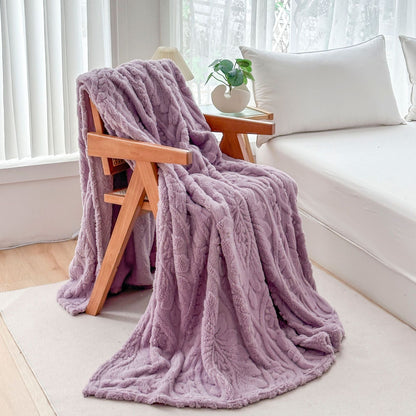 Purple fleece blanket draped over a wooden armchair