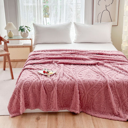Pink embossed fleece blanket over a bed with a tray on top