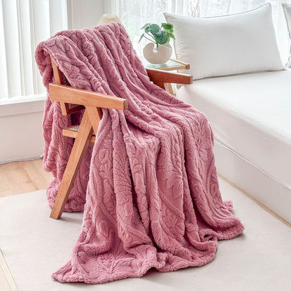 Pink fleece blanket draped over a wooden armchair