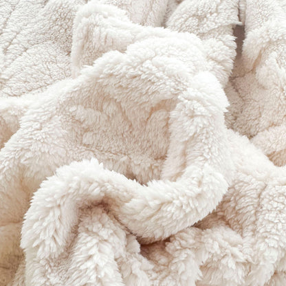 Close-up of the curly pile on the ivory fleece blanket