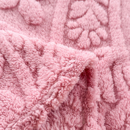 Close-up of the raised flower motif and pile on the pink fleece blanket