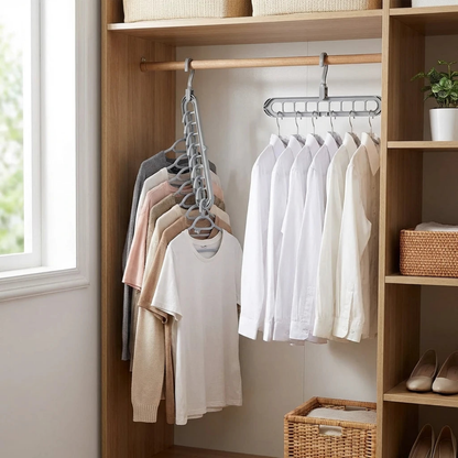 Two gray nine-slot hangers in a fitted oak wardrobe, the left one turned vertical with garments stacked down it and the right one hanging level with shirts side by side