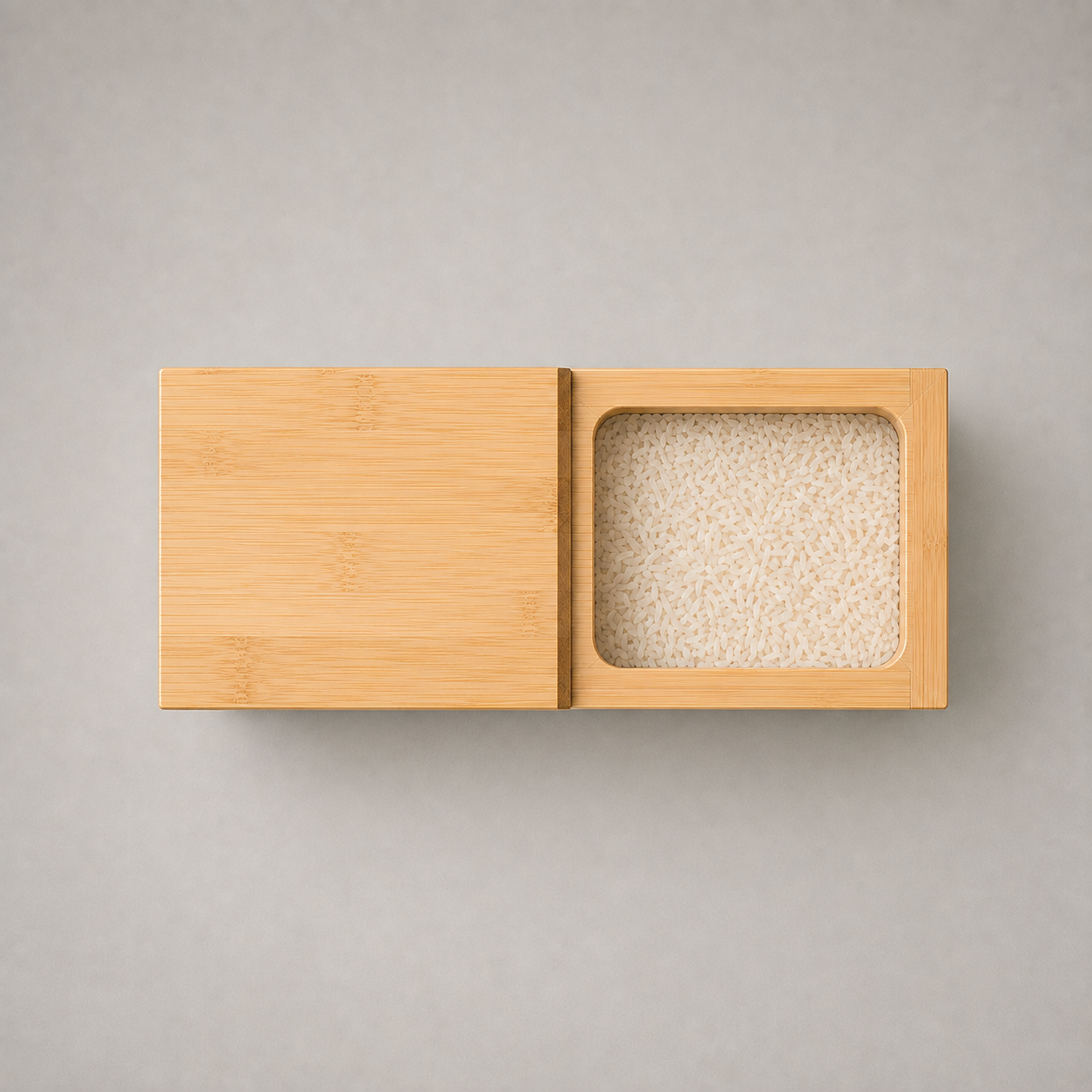 Close-up of the bamboo top showing the sliding lid, its thumb lip and the mouth full of rice
