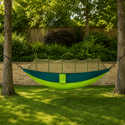 Green double hammock hung in a back garden, dark teal over lime, net held up by the ridgeline cord